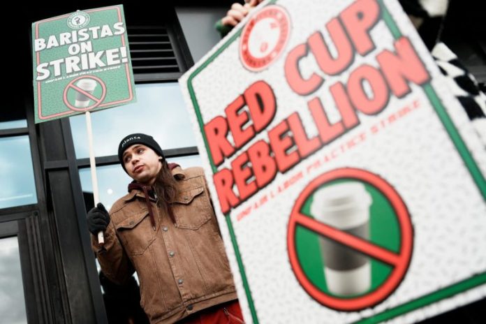 More than 1,000 unionized Starbucks workers went on strike at 65 U.S. stores Thursday to protest a lack of progress in labor negotiations with the company.
The strike was intended to disrupt Starbucks’ Red Cup Day, which is typically one of the company’s busiest days of the year. Since 2018, Starbucks has given out free, reusable cups on that day to customers who buy a holiday drink. Starbucks Workers United, the union organizing baristas, said Thursday morning that the strike had already closed some stores and was expected to force more to close later in the day.
Starbucks Workers United said stores in 45 cities would be impacted, including New York, Philadelphia, Minneapolis, San Diego, St. Louis, Dallas, Columbus, Ohio, and Starbucks’ home city of Seattle. There is no date set for the strike to end, and more stores are prepared to join if Starbucks doesn’t reach a contract agreement with the union, organizers said.
Starbucks emphasized that the vast majority of its U.S. stores would be open and operating as usual Thursday. The coffee giant has 10,000 company-owned stores in the U.S., as well as 7,000 licensed locations in places like grocery stores and airports.
As of noon Thursday on the East Coast, Starbucks said it was on track to meet or exceed its sales expectations for the day at its company-owned stores.
“The day is off to an incredible start,” the company said in a statement.
Around 550 company-owned U.S. Starbucks stores are unionized. More have voted to unionize, but Starbucks closed 59 unionized stores in September as part of a larger reorganization campaign.
Here’s what’s behind the strike.
Striking workers say they’re protesting because Starbucks has yet to reach a contract agreement with the union. Starbucks workers first voted to unionize at a store in Buffalo in 2021. In December 2023, Starbucks vowed to finalize an agreement by the end of 2024. But in August of last year, the company ousted Laxman Narasimhan, the CEO who made that promise. The union said progress has stalled under Brian Niccol, the company’s current chairman and CEO. The two sides haven’t been at the bargaining table since April.
Workers say they’re seeking better hours and improved staffing in stores, where they say long customer wait times are routine. They also want higher pay, pointing out that executives like Niccol are making millions and the company spent $81 million in June on a conference in Las Vegas for 14,000 store managers and regional leaders.
Dochi Spoltore, a barista from Pittsburgh, said in a union conference call Thursday that it’s hard for workers to be assigned more than 19 hours per week, which leaves them short of the 20 hours they would need to be eligible for Starbucks’ benefits. Spoltore said she makes $16 per hour.
“I want Starbucks to succeed. My livelihood depends on it,” Spoltore said. “We’re proud of our work, but we’re tired of being treated like we’re disposable.”
The union also wants the company to resolve hundreds of unfair labor practice charges filed by workers, who say the company has fired baristas in retaliation for unionizing and has failed to bargain over changes in policy that workers must enforce, like its decision earlier this year to limit restroom use to paying customers.
Starbucks says it offers the best wage and benefit package in retail, worth an average of $30 per hour. Among the company’s benefits are up to 18 weeks of paid family leave and 100% tuition coverage for a four-year college degree. In a letter to employees last week, Starbucks’ Chief Partner Officer Sara Kelly said the union walked away from the bargaining table in the spring.
Kelly said some of the union’s proposals would significantly alter Starbucks’ operations, such as giving workers the ability to shut down mobile ordering if a store has more than five orders in the queue.
Kelly said Starbucks remained ready to talk and “believes we can move quickly to a reasonable deal.” Kelly also said surveys showed that most employees like working for the company, and its barista turnover rates are half the industry average.
Unionized workers have gone on strike at Starbucks before. In 2022 and 2023, workers walked off the job on Red Cup Day. Last year, a five-day strike ahead of Christmas closed 59 U.S. stores. Each time, Starbucks said the disruption to its operations was minimal. Starbucks Workers United said the new strike is open-ended and could spread to many more unionized locations.
The number of non-union Starbucks locations dwarfs the number of unionized ones. But Todd Vachon, a union expert at the Rutgers School of Management and Labor Relations, said any strike could be highly visible and educate the public on baristas’ concerns.
Unlike manufacturers, Vachon said, retail industries depend on the connection between their employees and their customers. That makes shaming a potentially powerful weapon in the union’s arsenal, he said.
Starbucks’ same-store sales, or sales at locations open at least a year, rose 1% in the July-September period. It was the first time in nearly two years that the company had posted an increase. In his first year at the company, Niccol set new hospitality standards, redesigned stores to be cozier and more welcoming, and adjusted staffing levels to better handle peak hours.
Starbucks also is trying to prioritize in-store orders over mobile ones. Last week, the company’s holiday drink rollout in the U.S. was so successful that it almost immediately sold out of its glass Bearista cup. Starbucks said demand for the cup exceeded its expectations, but it wouldn’t say if the Bearista will return before the holidays are ove
This post appeared first on NBC NEWS